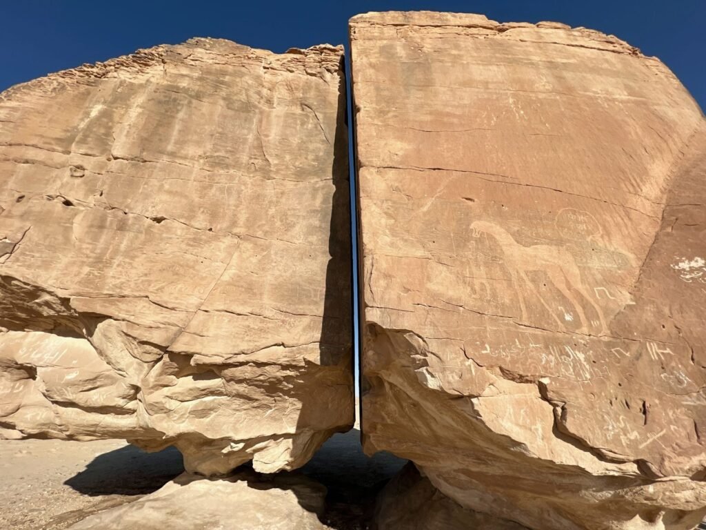 Stunning Al Naslaa rock formation in Saudi Arabia featuring ancient petroglyphs