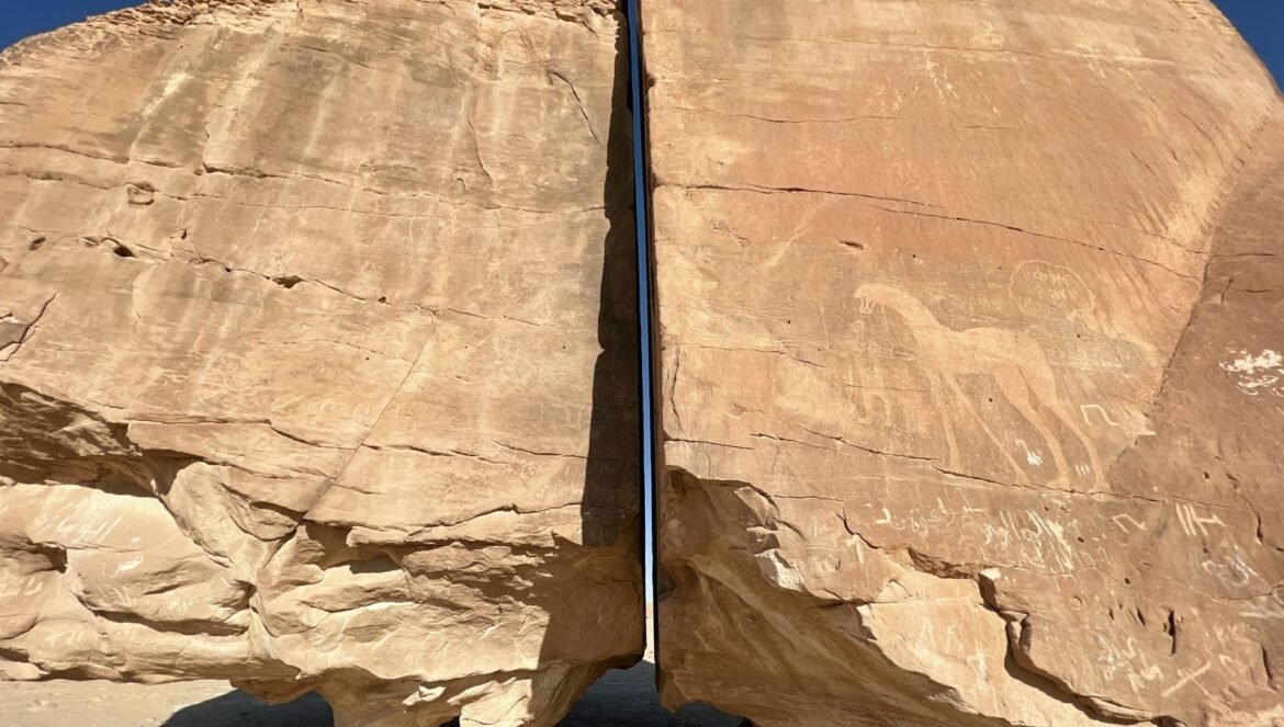 Stunning Al Naslaa rock formation in Saudi Arabia featuring ancient petroglyphs