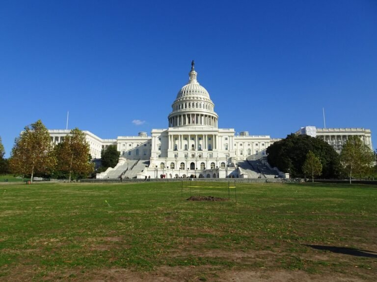 The iconic United States Capitol Building in Washington, D.C., under a clear blue sky