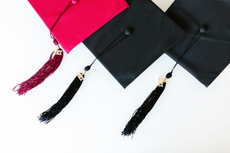Vibrant red and black graduation caps with 2024 tassels on a white background