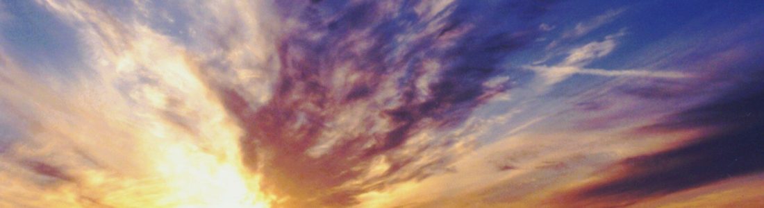 Dramatic sunset sky over a coastal landscape